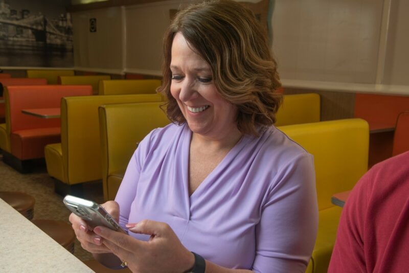 smiling woman on phone
