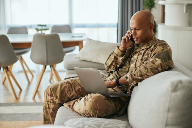 Man in camouflage using laptop on sofa 2026 01 06 10 29 19 utc