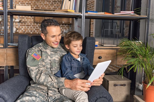 Man in military uniform with a child looking at ta 2026 03 11 06 53 28 utc